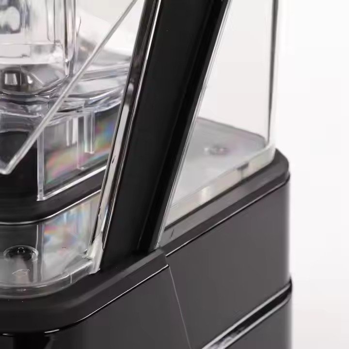 Close-up detail of the integrated sound insulation cover on the AIMA OTJ-KC80 blender, designed to reduce operational noise.