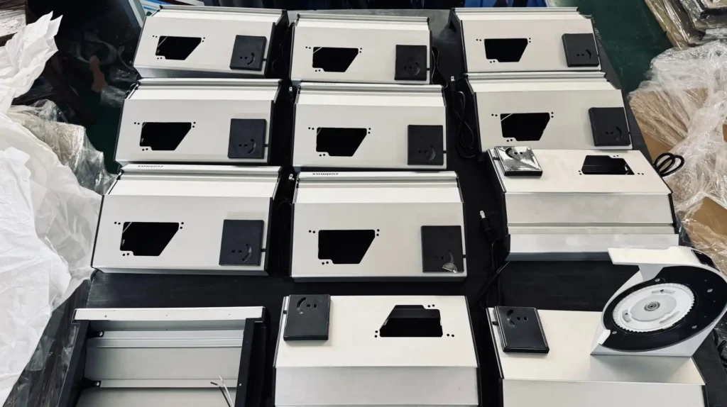Precision-engineered silver aluminum panels and blade guards for commercial meat slicers ready for B2B factory assembly.