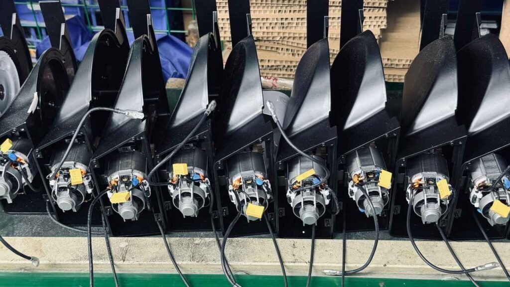 Blue crate filled with wired black plastic handles and control panels for meat slicer OEM manufacturing
